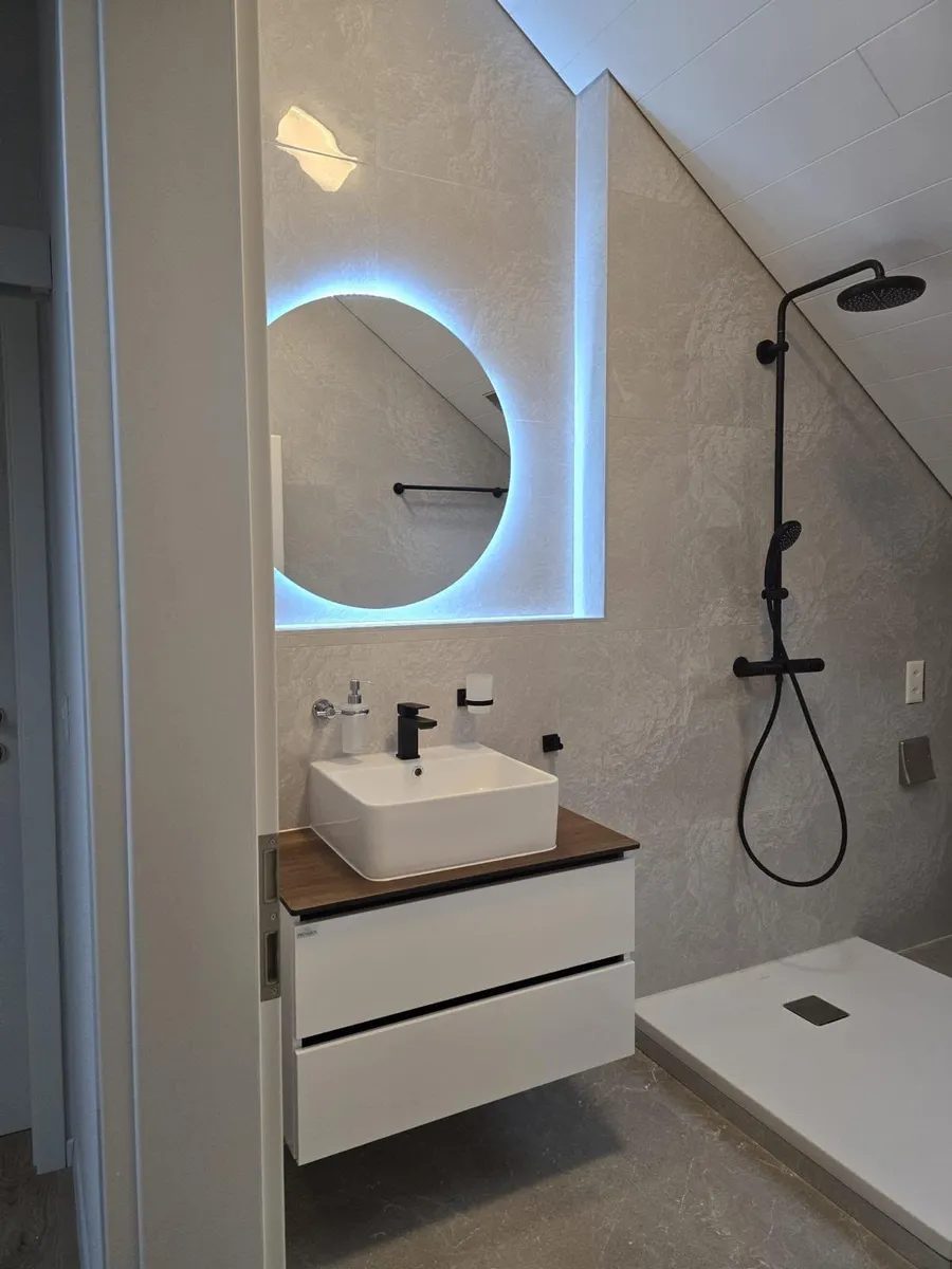 Salle de bain rénovée avec douche à l'italienne, meuble-vasque et miroir rétroéclairé, par MSCV SA